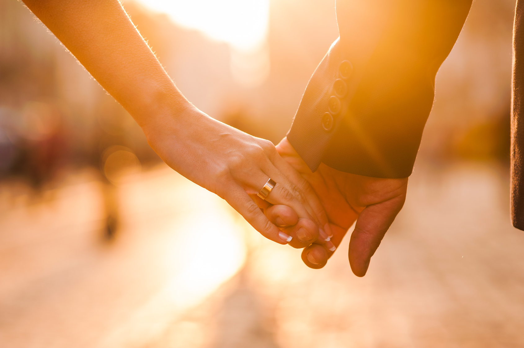 Beautiful couple holding hands at sunset