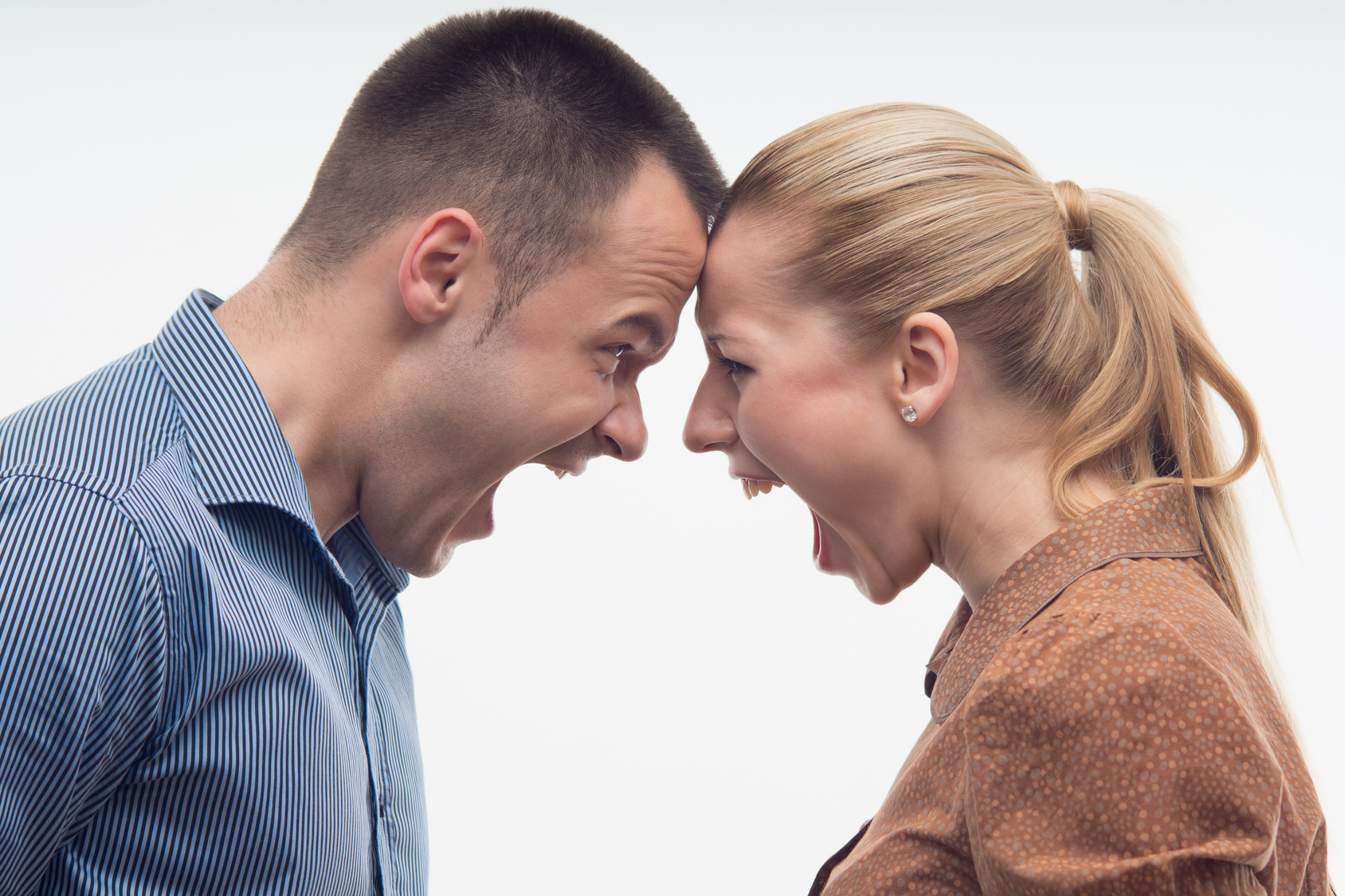 Colleagues fighting each other with foreheads together, staring with hostile expressions isolated on white